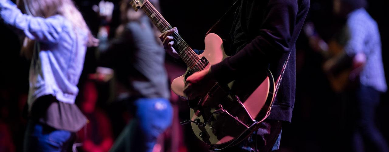 Student playing guitar