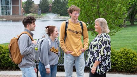 Students talking with teacher around Cedar Lake