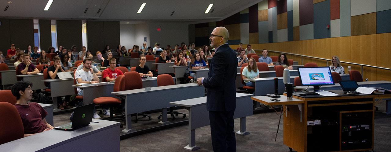 Dr. Michael McKay teaches New Testament Literature on the first day of his class fall semester with his wife, Lee-Ann, looking on from far left