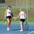 Twogirlshighfiveontenniscourt