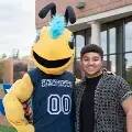 Stingermascotposingwithstudentoutside