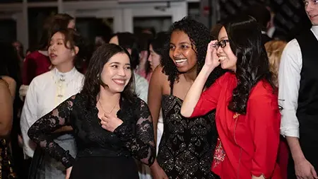 Group of three girls at the Embassy Gala hosted by international student organization