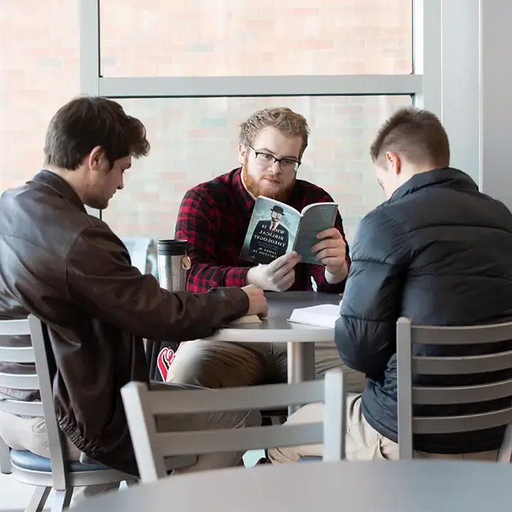 Three people seated at a table